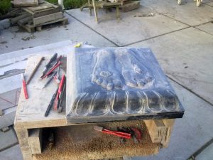 black granite padukas being carved and polished. Carving the lotus motif