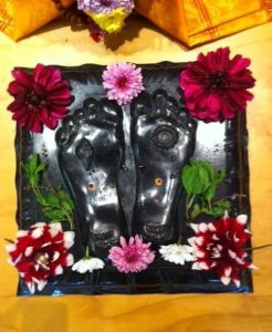 top view of balck granite padukas with flowers