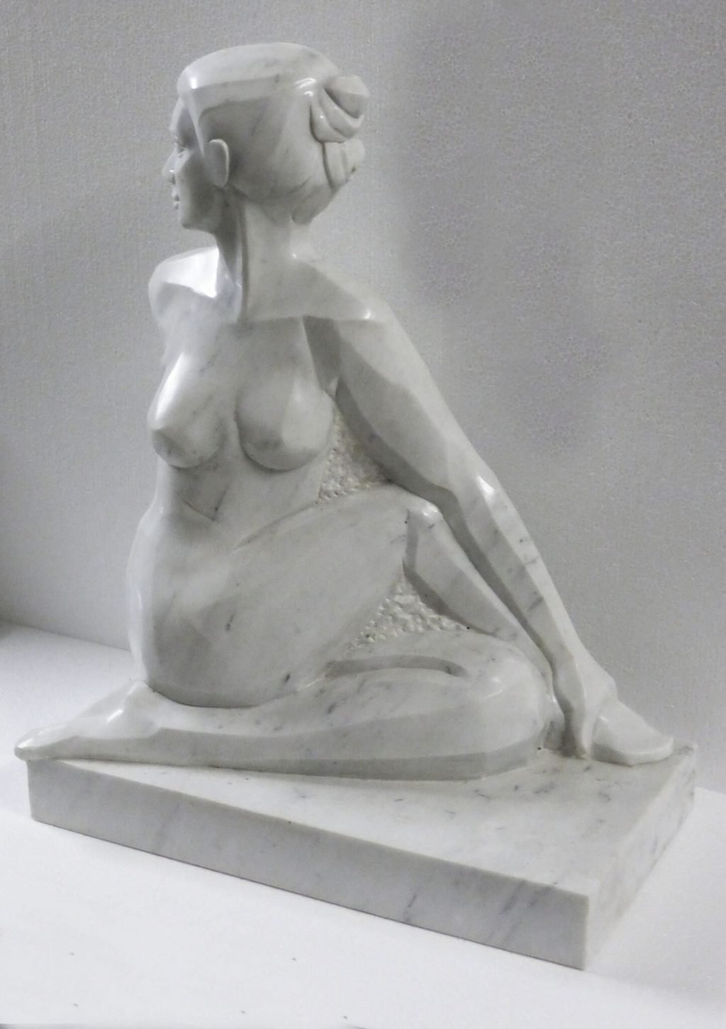 hatha yoga pose Ardha Matsyendrasana in white carrara marble